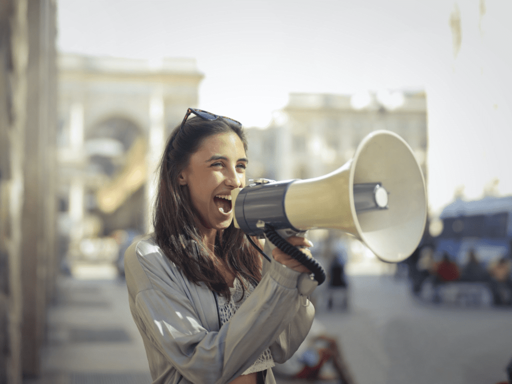 Alternative Text: Woman using megaphone to make a call-to-action Woman using megaphone to make a call-to-action
